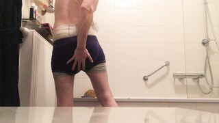 Removing a piss and shit filled diaper